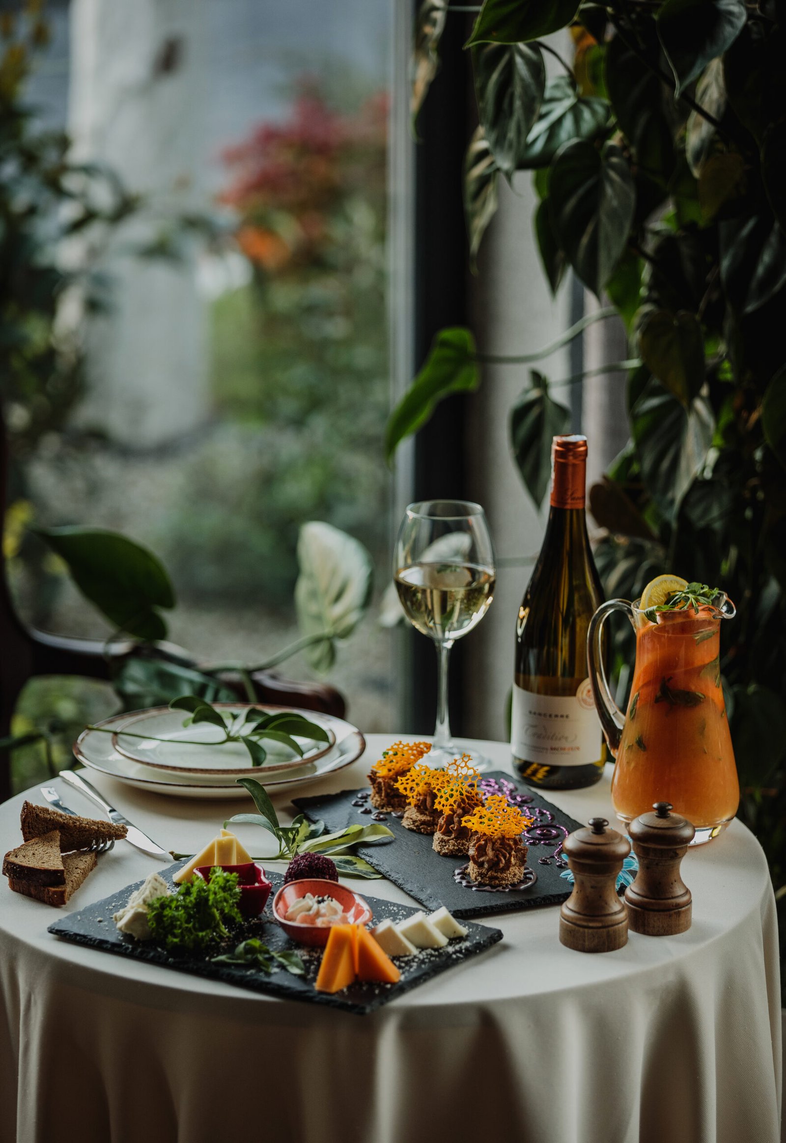 side view of a table with cheese plate and pate on it